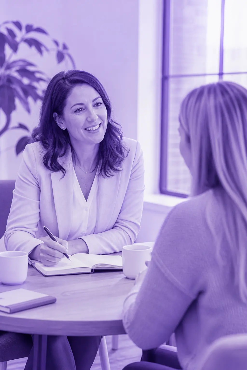 A Roimatics coach in a one-to-one session with a client at a small table